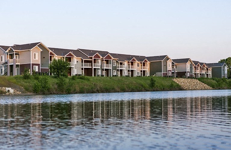 a row of houses next to a body of water