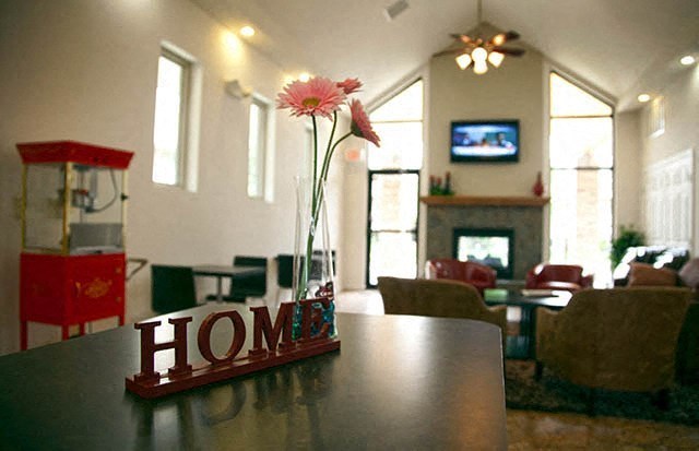 a table with a vase with flowers on it