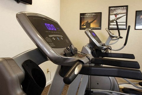 a treadmill in a gym with some exercise equipment