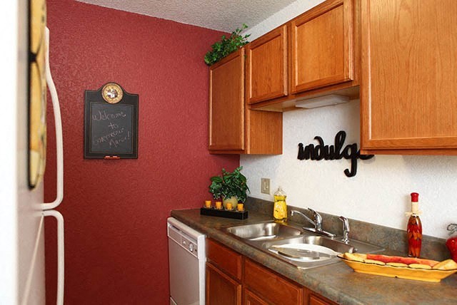 a kitchen with a sink and a refrigerator