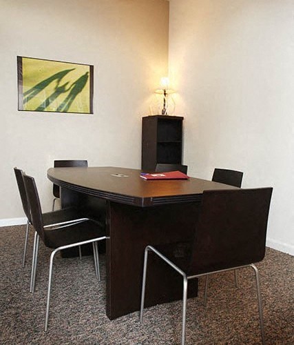 a conference room with a table and chairs