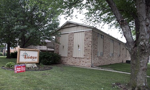 a church building with a sign in front of it