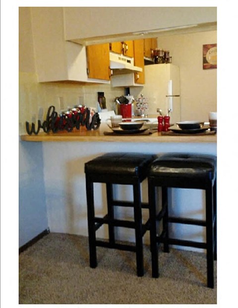 two bar stools in front of a kitchen counter