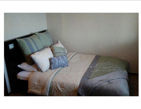 a bedroom with a bed and pillows on it