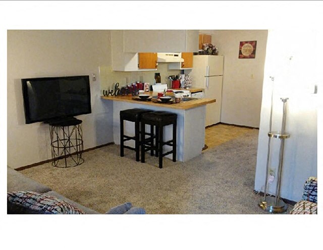 a small kitchen with a counter and a tv