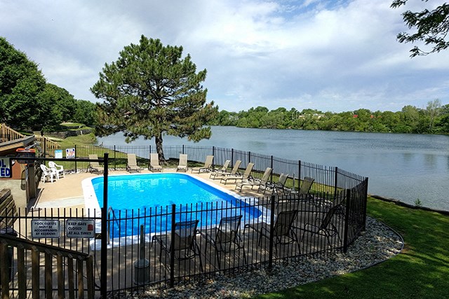 the pool is overlooking the lake at the resort