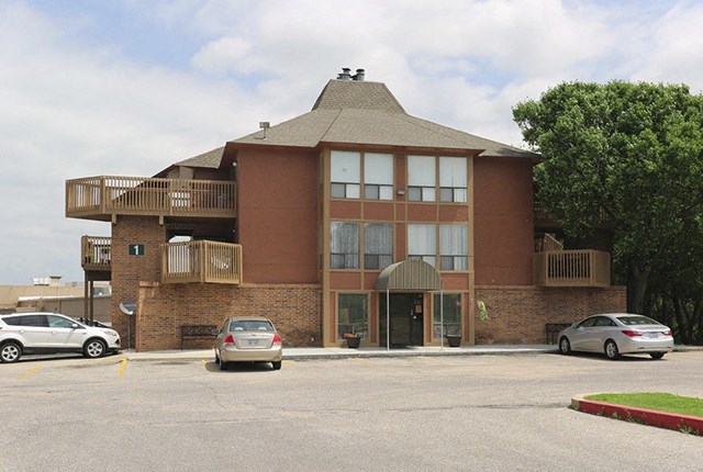 a building with cars parked in a parking lot