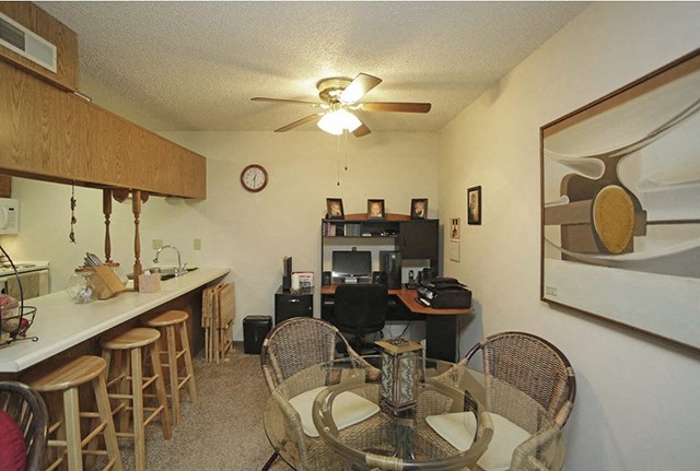 a dining room and kitchen with a table and chairs