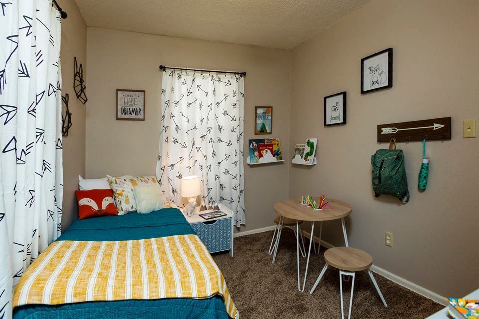 a bedroom with a bed and a table in it