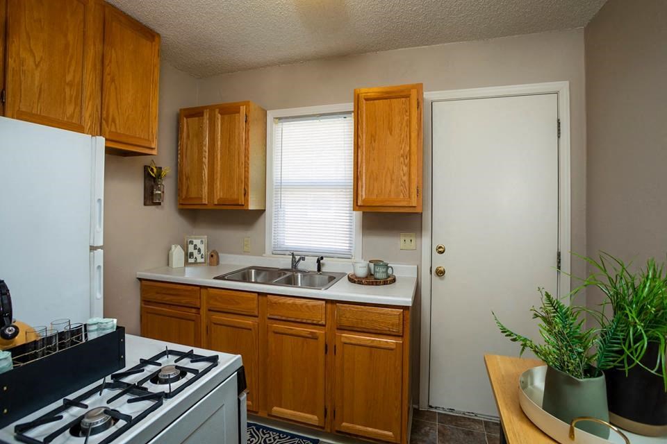 a kitchen with a sink and a stove