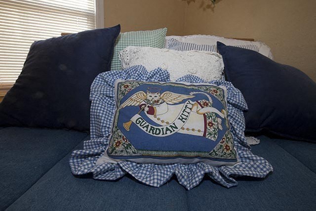 a bed with blue pillows and a pillow with the word burlap on it