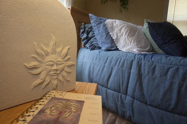a bedroom with a bed and a book on the floor
