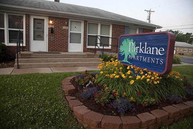 a apartments sign in front of a house