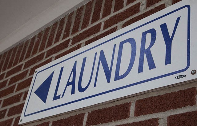 a sign on the side of a brick wall