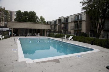 a swimming pool in front of an apartment building