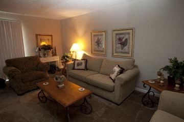 a living room with a couch and two chairs