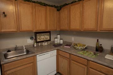 a kitchen with white appliances and wooden cabinets