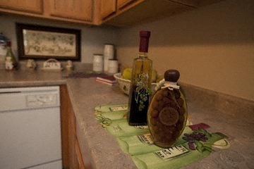 a kitchen counter with a bottle of wine on it
