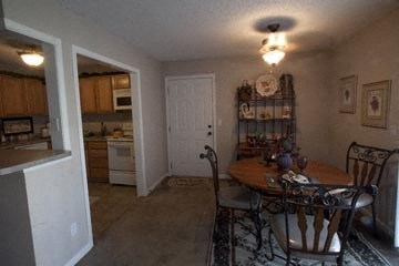 a kitchen and dining room with a table and chairs