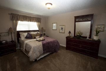 a bedroom with a bed and a dresser