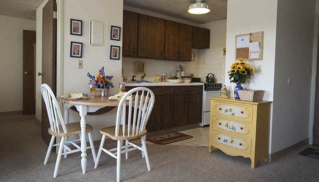 a kitchen and dining room with a table and chairs