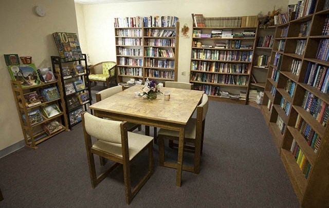 a library with a table and chairs in it