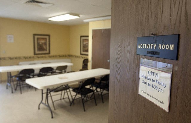 a room with tables and chairs and a sign that says activity room