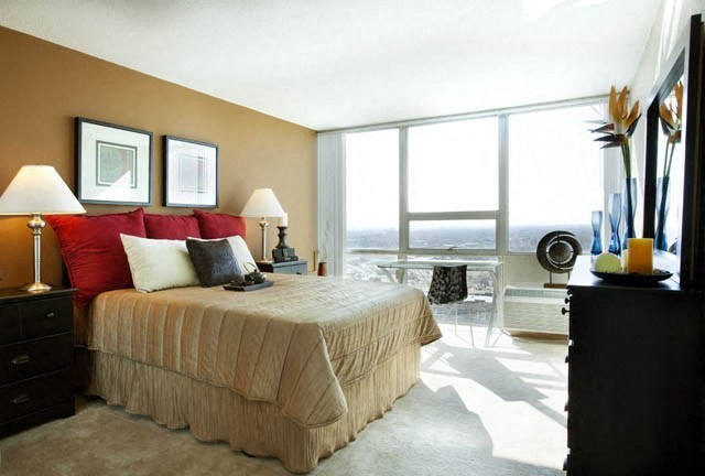 a bedroom with a bed and a large window