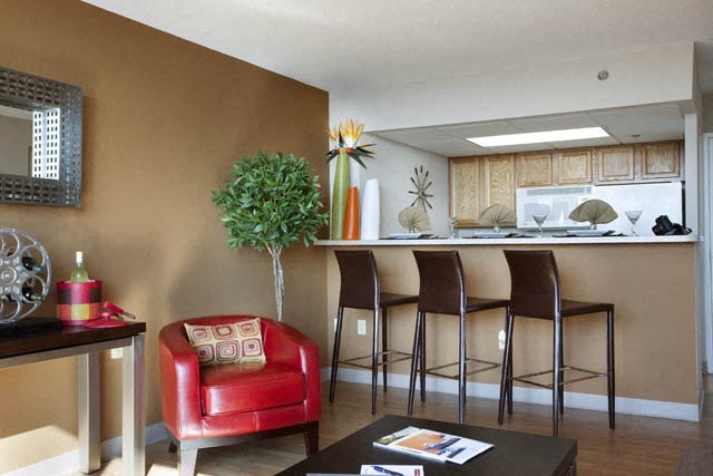 a living room with a bar and a kitchen