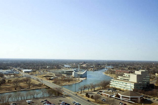 an aerial view of a city with a river and buildings