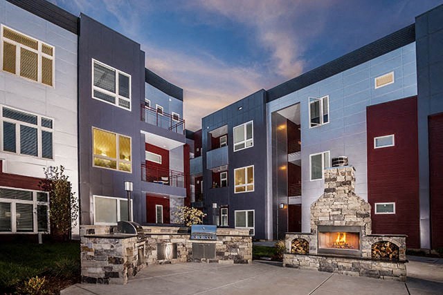 a group of houses with a fireplace in front of them
