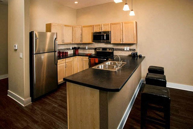 a kitchen with a stainless steel refrigerator and a counter top