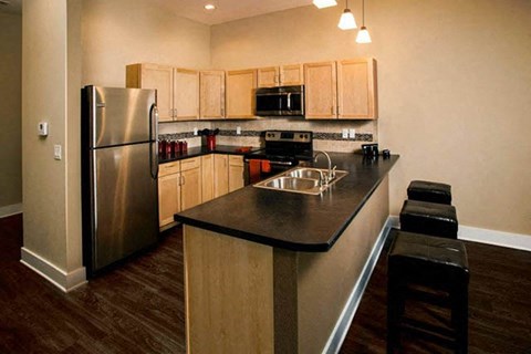 a kitchen with a stainless steel refrigerator and a counter top