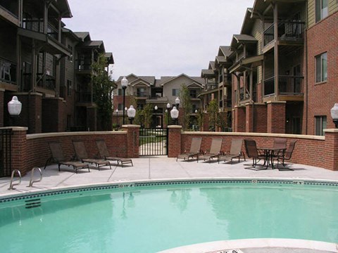a swimming pool in front of an apartment building