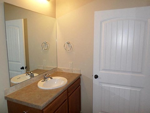 a bathroom with a sink and a white door