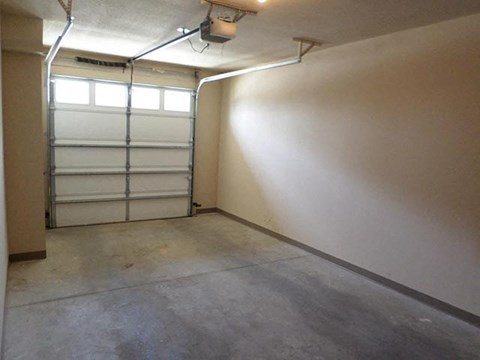 a garage with a white wall and a garage door