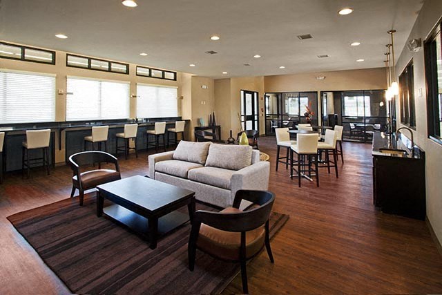 a large living room with a couch and tables