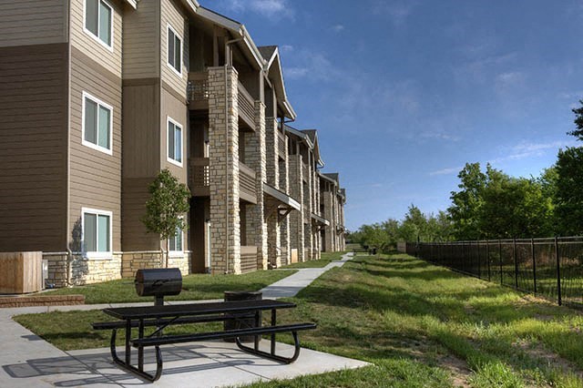 a picnic table in front of a row of houses