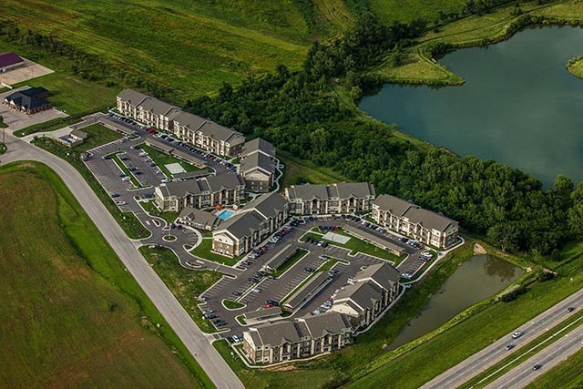 an aerial view of a campus with a body of water