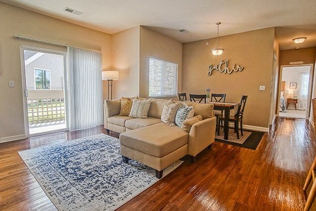 a living room with a couch and a dining room table
