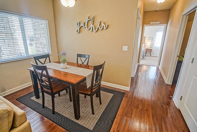 a dining room with a wooden table and chairs