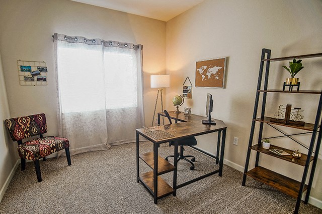 an office with a desk and a chair and a window