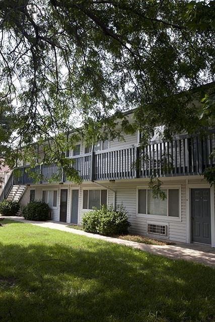 a white house with a balcony and a yard