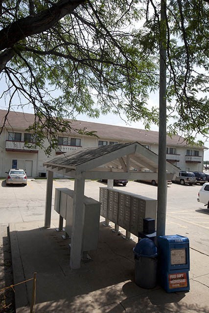 a bus stop on the side of a parking lot