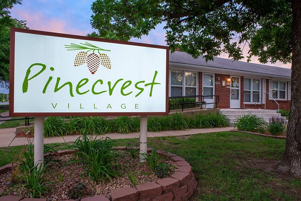 the sign in front of the vineyard village office building