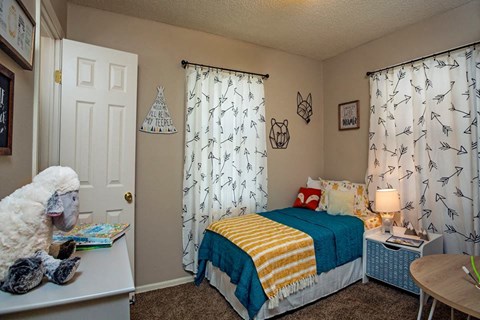 a bedroom with a bed and a desk