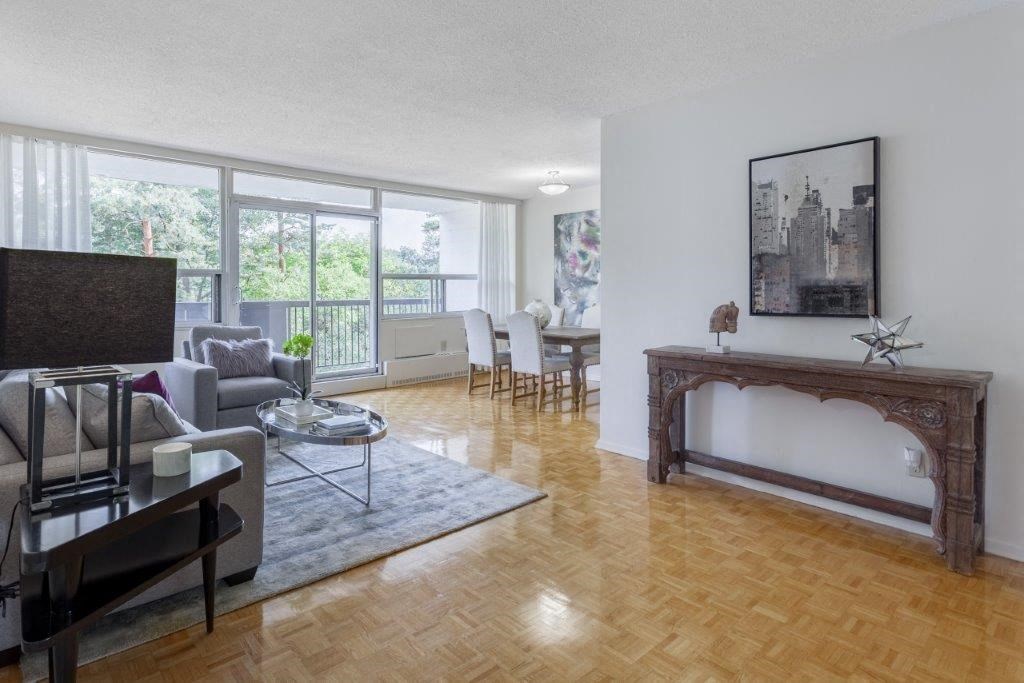a living room with a fireplace and a dining room