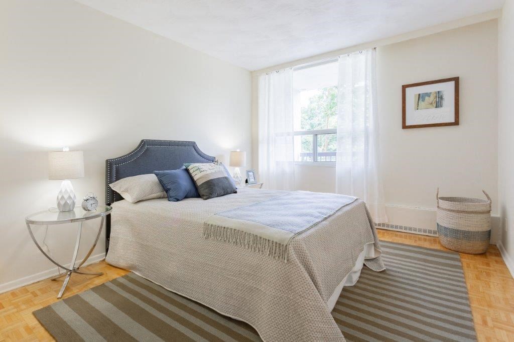 a bedroom with a bed and a window