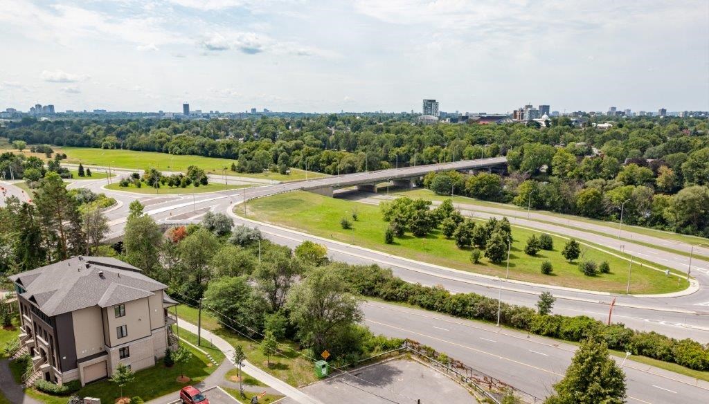 an aerial view of a city with highways and trees