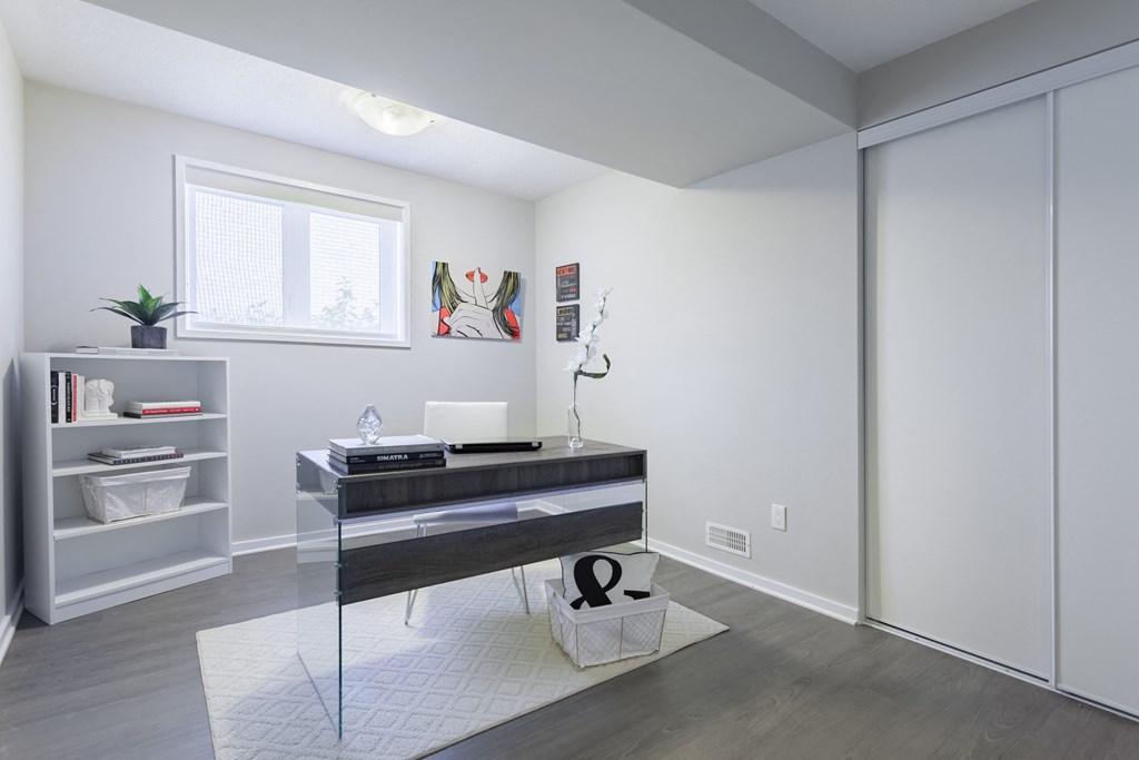 view of a living room with a desk and a window